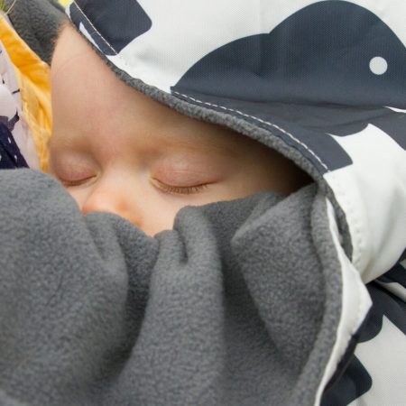 close up of baby in bundlebean baby carrier cover - fleece lined elephant design