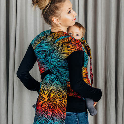 Woman carrying baby in Lenny Lamb Wrap Tai baby carrier in Wild Soul Daedalus fabric, back view