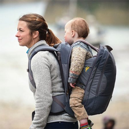 Woman carries baby in LittleLife Traveller S4 Child Carrier backpack, side view