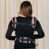 Back view of woman carrying baby facing towards her in Ombre Pink Lenny Lamb LennyUpgrade mesh baby carrier showing rucksack straps