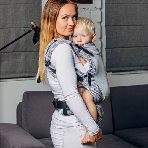Side view of woman carrying baby facing towards her in Lenny Lamb LennyUpgrade mesh baby carrier in grey Selenite fabric