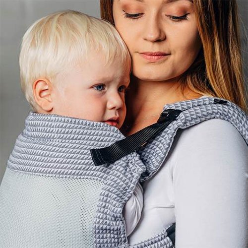 Close up of woman carrying baby facing towards her in Lenny Lamb LennyUpgrade mesh baby carrier in grey Selenite fabric