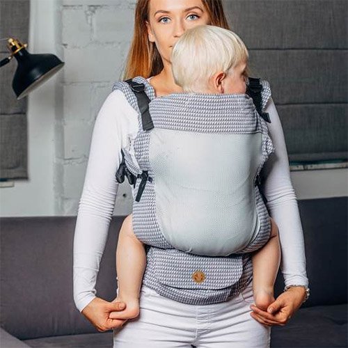 Woman carrying baby facing towards her in Lenny Lamb LennyUpgrade mesh baby carrier in grey Selenite fabric