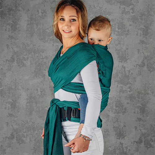 Woman carries toddler on her back in Lenny Lamb LennyHybrid Preschool toddler carrier in Emerald, front view