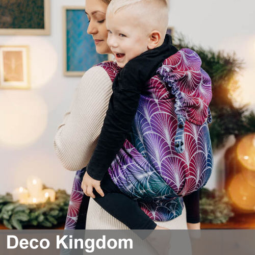 Woman carries toddler on her back in Lenny Lamb LennyHybrid Preschool toddler carrier in Deco Kingdom fabric, back view