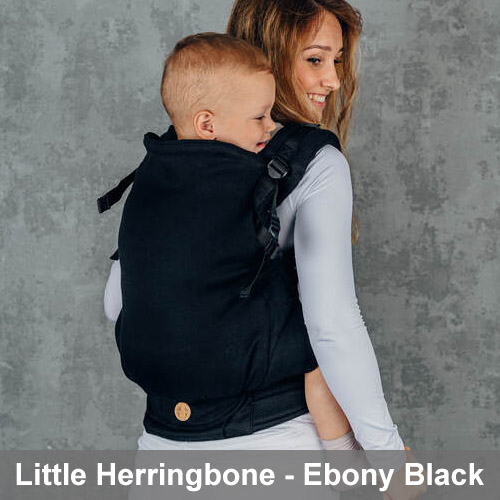 Woman carries toddler on her back in Lenny Lamb Preschool carrier in Little Herringbone fabric in Ebony Black