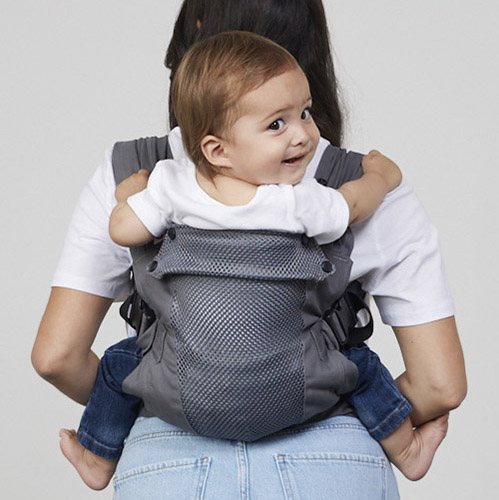 Woman carries baby on her back in Izmi Breeze Baby Carrier, back view