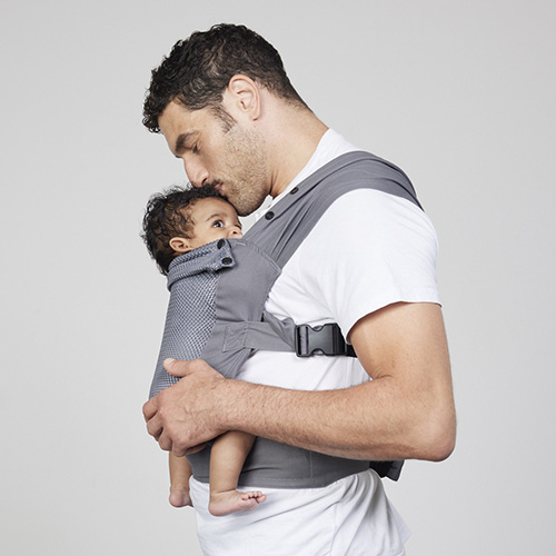 Man carries baby on his chest in Izmi Breeze Baby Carrier, side view