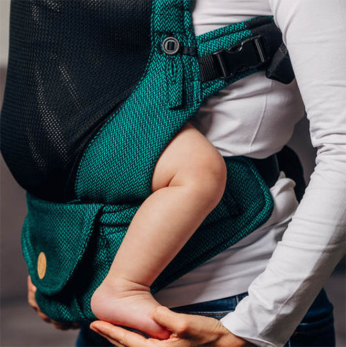 Side view of woman carrying baby facing towards her in Lenny Lamb LennyUpgrade mesh baby carrier in Emerald green fabric