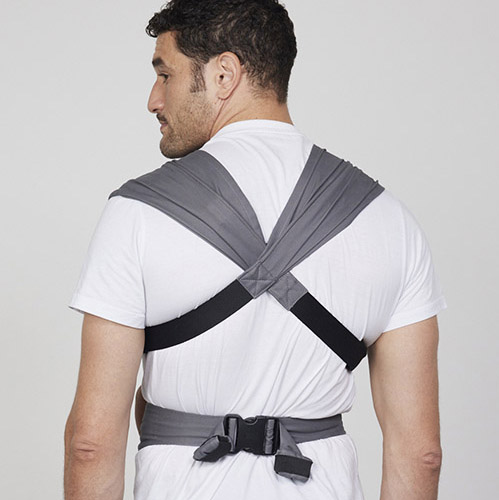 Back view of man wearing Izmi Baby Carrier showing crossed straps