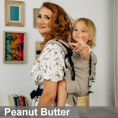 Woman carries toddler on her back in Lenny Lamb Preschool carrier in beige Peanut Butter colourway